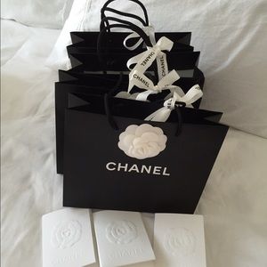 Four small Chanel shopping bags
