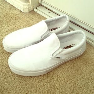 All white Vans Slip Ons