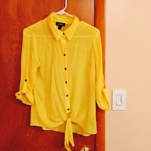 Bright yellow button down blouse.