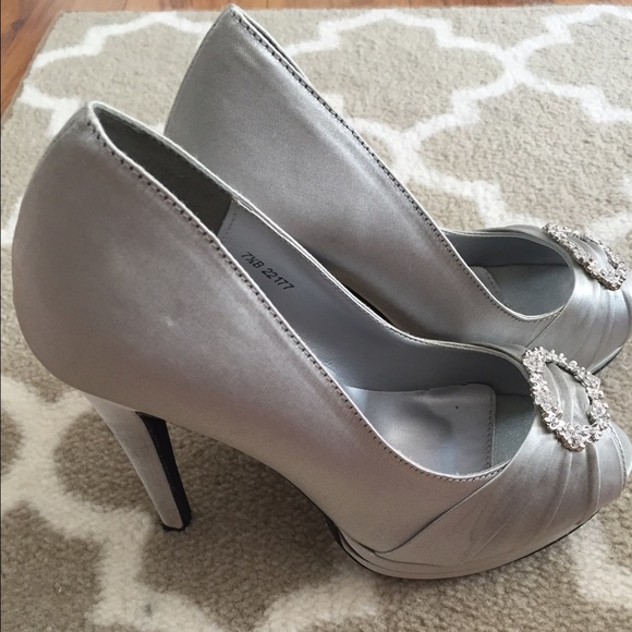 Silver heels with silver detailing.