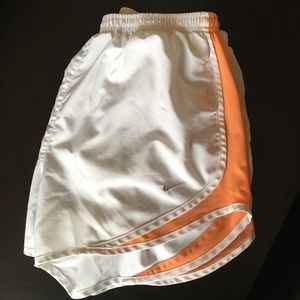 White and orange Nike running shorts