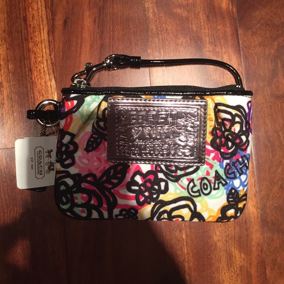 Coach wristlet. Multi colored floral print