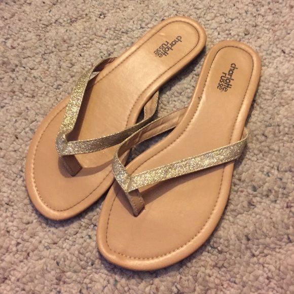 Gold glittery flip flops