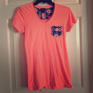 Cute peach colored Aztec print pocket v neck shirt
