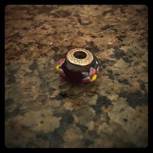 Pink and yellow flower on mauve bead