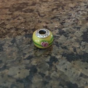 Pink flower on yellow & green swirl bead