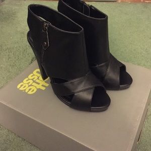 Heeled Black leather shoes.