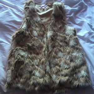 Tan furry vest.