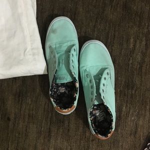 Tiffany blue vans with floral patter inside.