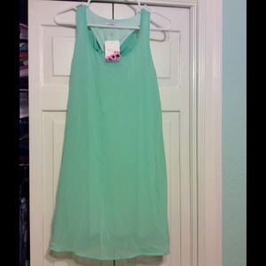 Mint green dress with ribbon on the back.