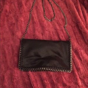 Fold over chain trim clutch with chain strap