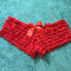 Coquette ruffled booty shorts in red.