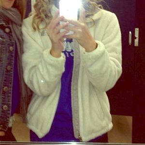 White fuzzy north face jacket