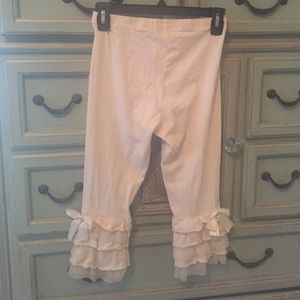 The cutest cream leggings with fun ruffle bottom!