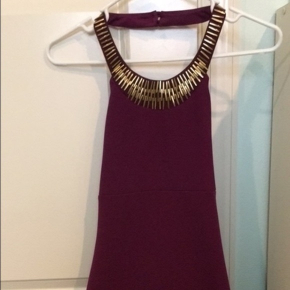 Maroon colored tie dress with gold neckpiece
