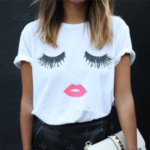 White tee with eyelashes and pink lips.