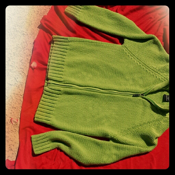 Zippered cotton sweater. Lands just above hip.