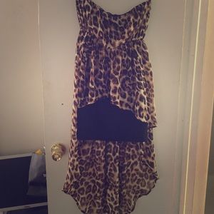 A sleeveless dress with a long back cheetah print