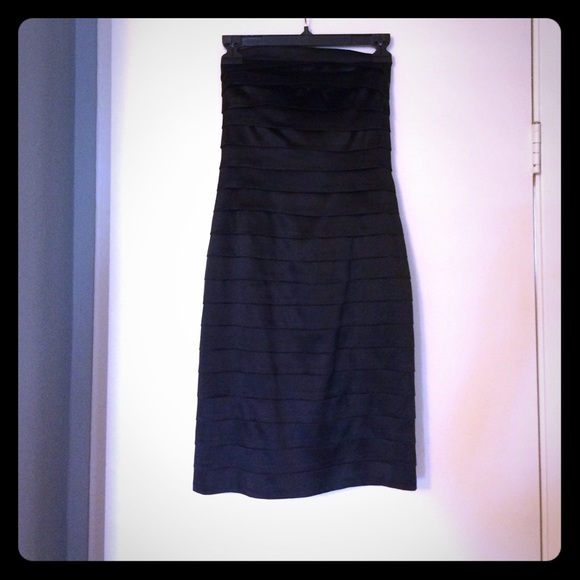 Bebe; Sleeveless black satin dress; form fitting.