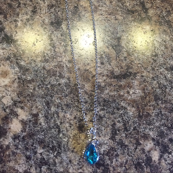 Necklace with silver chain and Aqua blue pendent.