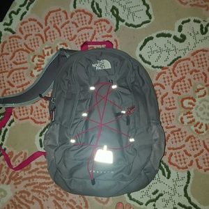Grey and pink north face backpack