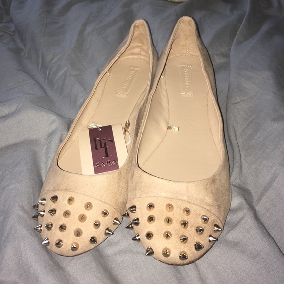 Tan flats with spiked toes and heels