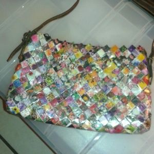 A laminated,  handmade purse made of recycled pap