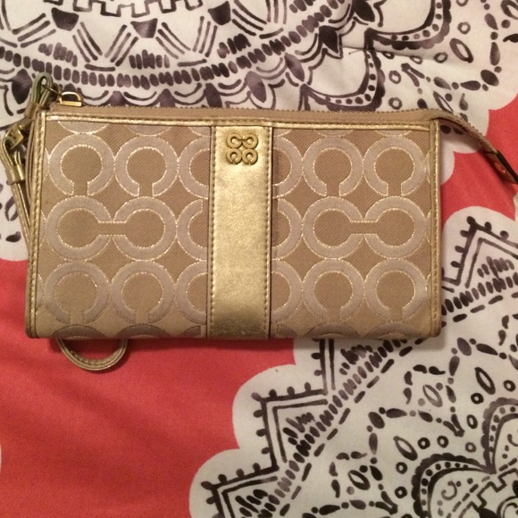 Super cute and stylish gold coach wristlets!