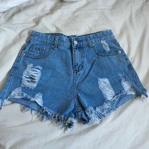 High waisted distressed medium wash denim shorts