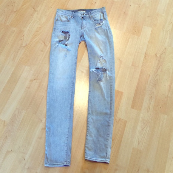 Worn light blue denim jeans