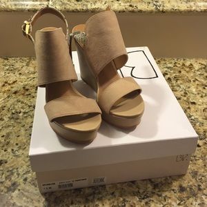 Nude wedges with snakeskin around heel.