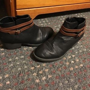 Black booties with brown buckles