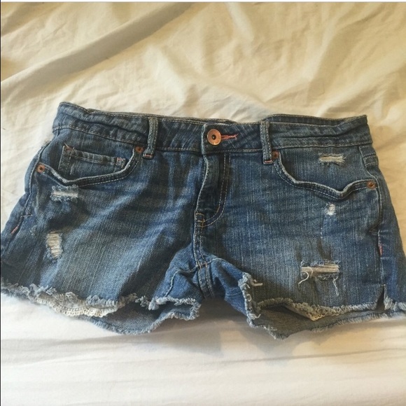 Low rise shorts with distressed designs all over