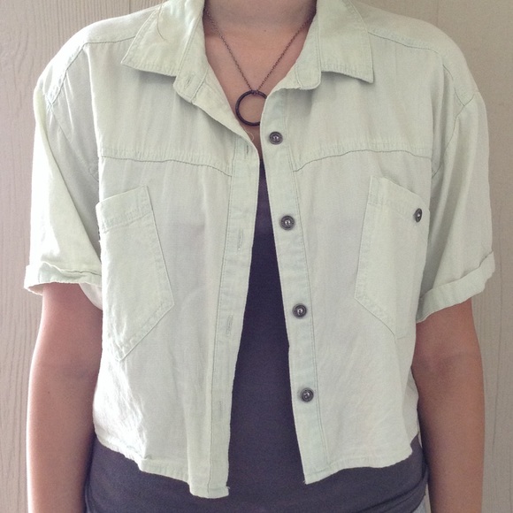 A mint green button up crop top