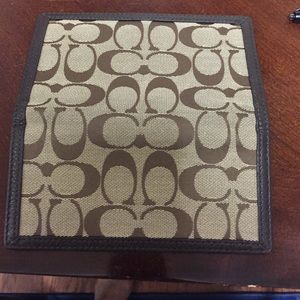 Coach checkbook cover.