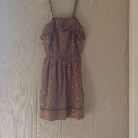A brown dress with a gold design- tag on it