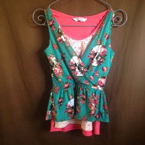 Lot of 2 skull design tank tops layered together.