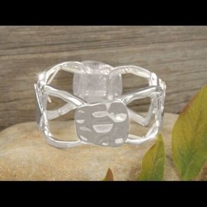 Hammered silvertone rings and tabs bracelet.