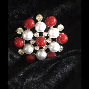 Red and white broach.
