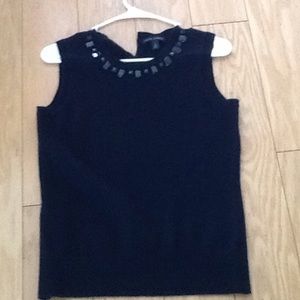 Sleeveless sweater with embellished neckline