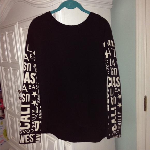 black shirt with writing on the sleeves