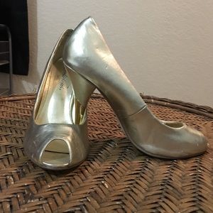 Gold patent leather open-toed heel.