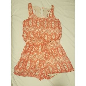 Like New. Light orange/white romper