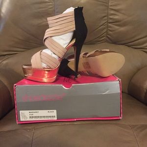 Black, gold and cream platform shoes.