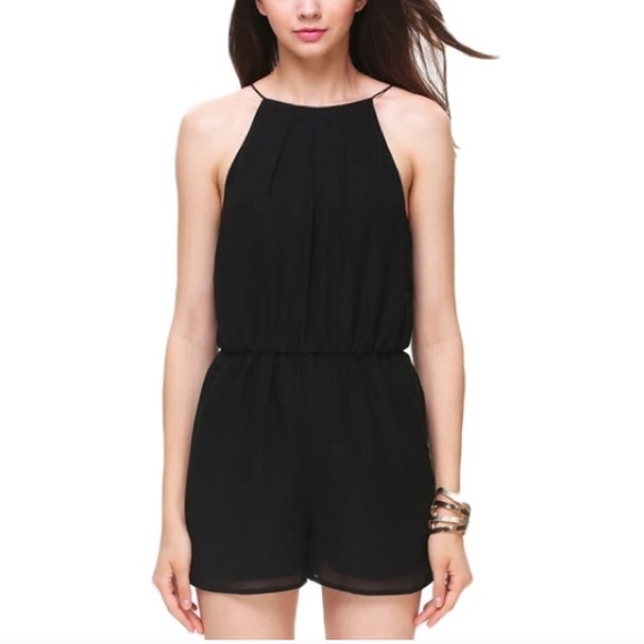 Black high neck romper with open back. Never worn