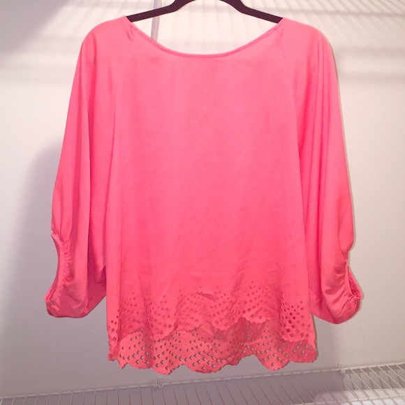 Coral blouse with scalloped laser cutouts