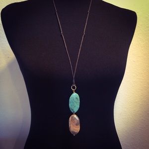 Long pendant with turquoise and brown stones.