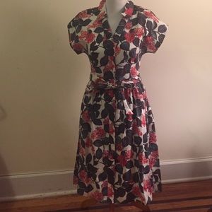 White dress with pink flowers and green leaves