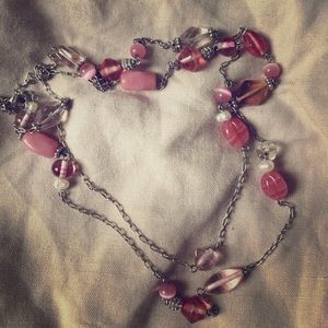 Long pink and silver tone beaded necklace.