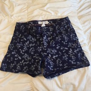 White leaf pattern blue shorts